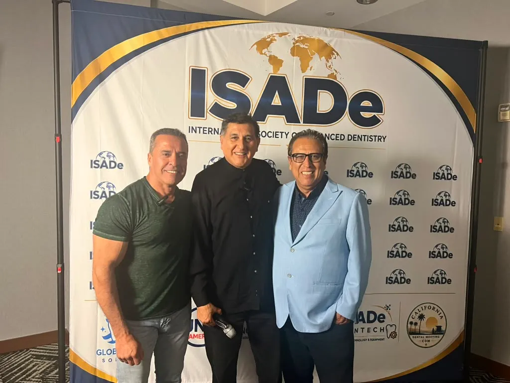 Colleagues together at the ISADe photo backdrop.
