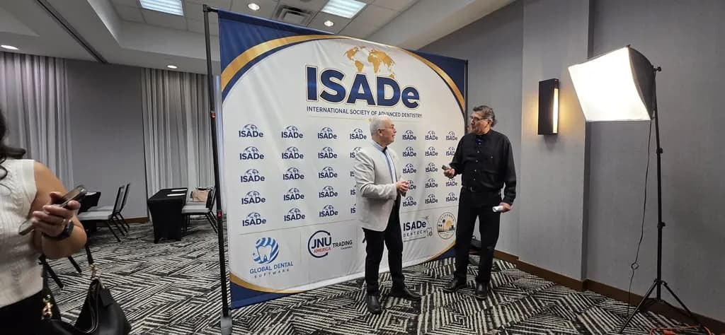 Faculty networking at the ISADe backdrop.